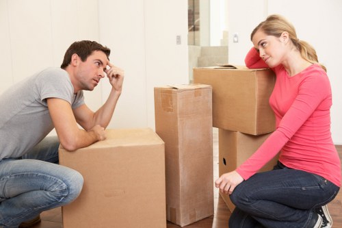 Professional movers carrying furniture during an East London relocation