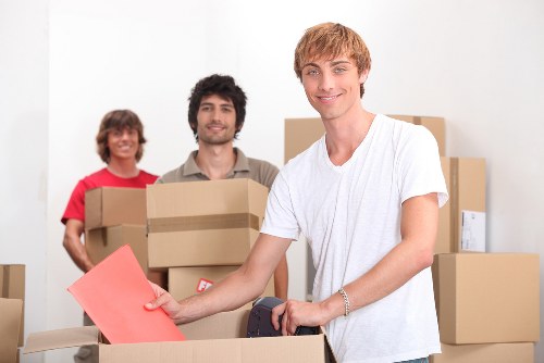 Residential movers assisting with furniture in a Shoreditch apartment